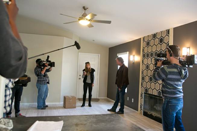 Scott and Amie Yancey, from A&E’s “Flipping Vegas,” check on the progress of one of their remodeling projects during a taping of their show Tuesday, Nov. 26, 2013.